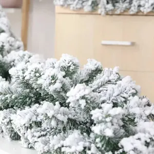 Macro detail of white flocked snow effect on green Christmas pine needle garland