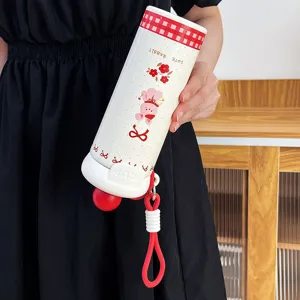 Detailed view of the cute portable stainless steel vacuum insulated cup with silicone strap.
