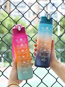 Detail view of two 750ml matte gradient water bottles with motivational time markers.