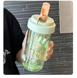 Detailed view showing the portable plastic straw cup with a flip-top lid and green body.