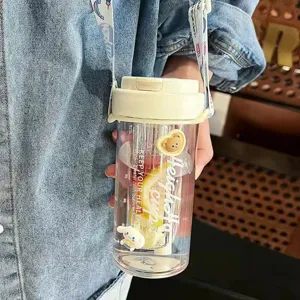 Detail of a portable plastic straw water bottle featuring Cinnamoroll and cute bear decorations.