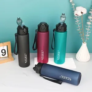 Frosted sports water bottle with straw and portable strap, 750ml capacity for outdoor sports.