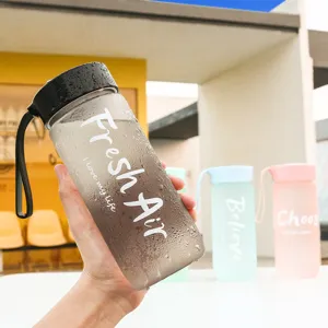 Bottiglia d'acqua in plastica opaca con coperchio nero e cinturino per lo sport quotidiano.