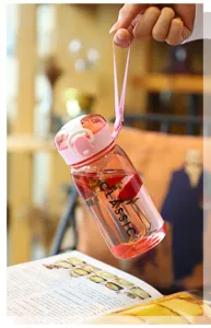 Portable clear plastic water bottle with straw and pink pop-up lid for outdoor sports.