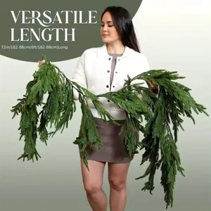 Model holding a 72-inch long faux Norfolk Pine Christmas garland for scale
