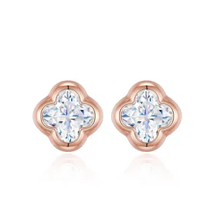 Macro view of rose gold clover stud earrings featuring sparkling moissanite stones