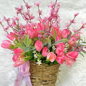 Close-up of artificial pink tulip flower basket with pink plaid ribbon for home decor