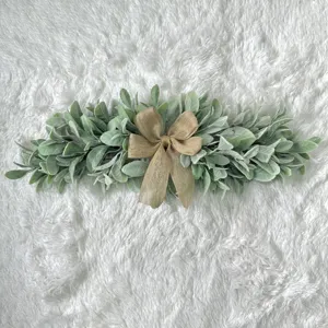 Artificial lamb's ear foliage door swag with a burlap bow for farmhouse wall decor.
