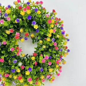 Detailed close-up of vibrant eucalyptus wreath with colorful artificial flowers