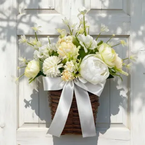 Close-up of artificial peony and daffodil flower basket with a silver bow hanging on a door
