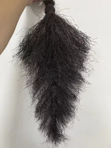 Macro detail of the dark brown woven plastic fibers of a decorative broom garland