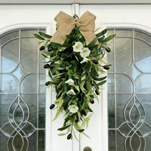 Detail of olive teardrop wreath with white morning glory flowers and a burlap bow