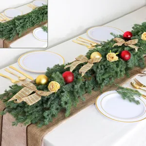 Detailed view of lush green artificial Norfolk Pine garland on a festive holiday table