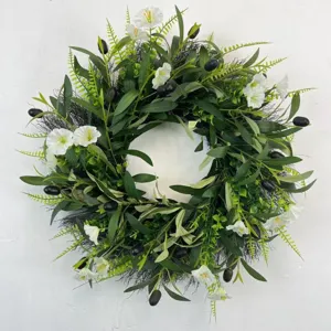 Close-up detail of artificial olive wreath with white bellflowers and black olives