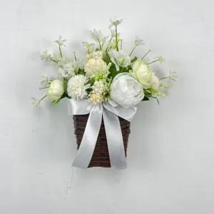 Detailed view of artificial white peony and narcissus flowers in a woven wall basket
