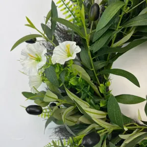 Close-up detail of artificial olive wreath with white bellflowers and black olives