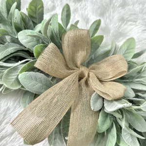 Close-up of a rustic lamb's ear wreath with a large burlap bow for farmhouse decor.
