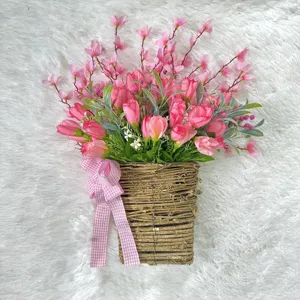 Detailed view of artificial pink tulip arrangement in a woven farmhouse wall basket