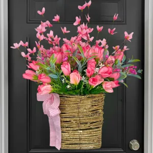 Close-up of pink artificial tulip flower basket with checkered ribbon for door decor.