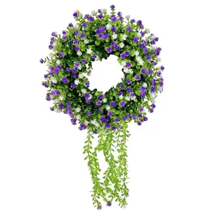 Decorative artificial eucalyptus wreath with purple flowers and trailing greenery