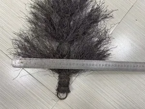 Detailed macro view of dark brown plastic rattan wreath base with metal ruler for scale