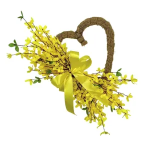 Detail view of heart-shaped wreath with yellow forsythia flowers and a large satin bow.