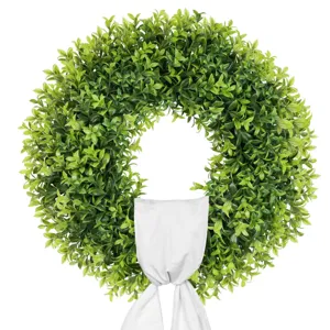Detailed view of lush green artificial boxwood wreath featuring a white ribbon bow accent