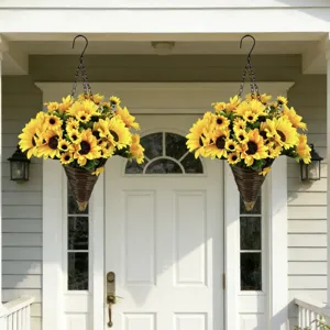 Close-up of two hanging baskets with artificial sunflowers on a white porch door