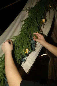 Macro detail of real-touch artificial Norfolk pine garland for DIY Christmas decor.