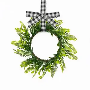 Artificial green fern leaf wreath with black and white buffalo plaid bow for door decor