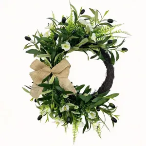 Artificial olive wreath with black berries, white flowers, and a natural burlap bow.