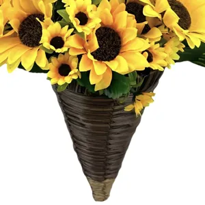 Close-up of vibrant artificial sunflowers in a conical woven hanging wall basket