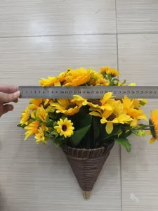 Detailed measurement of the artificial sunflower hanging basket with a metal ruler.