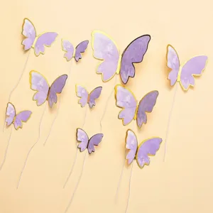 Detail of purple butterfly cake toppers with gold foil edges for birthday party decoration.