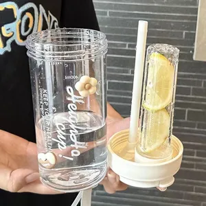 Clear plastic water bottle with drinking straw and built-in lemon fruit infuser cup