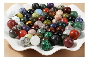 Close-up of assorted 20mm natural gemstone spheres in a white decorative bowl.