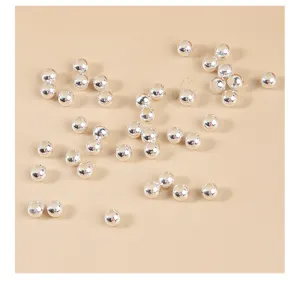 Detailed top view of scattered S925 sterling silver round spacer beads for DIY jewelry