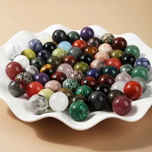 Assorted 20mm natural crystal and gemstone spheres in a decorative bowl for DIY jewelry