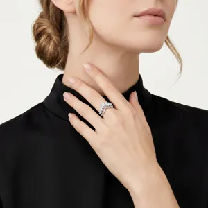 Close-up of elegant V-shaped silver ring with marquise-cut stones worn by model