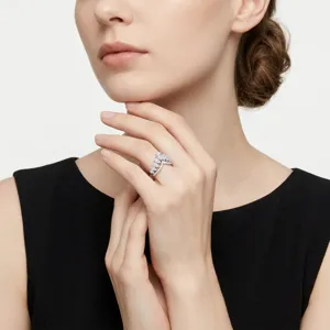 Close-up detail of a silver V-shaped ring with marquise diamonds on a model's hand