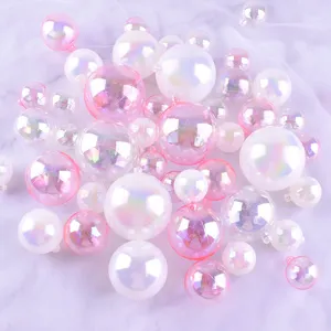 Close-up detail of assorted iridescent and pink holographic bubble balls for cake decorating.