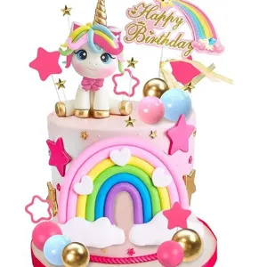 Unicorn birthday cake topper set with rainbow, clouds, and stars for kids party decor.