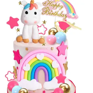 Unicorn birthday cake topper set with rainbow cloud and stars for kids party decor.