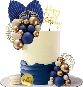 Bohemian cake topper set with blue and gold balloons, fan leaves and happy birthday sign.