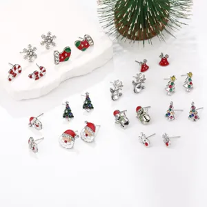Close-up of festive Christmas stud earrings with colorful enamel and rhinestones