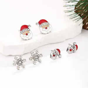Detailed macro shot of Christmas themed earring set featuring Santa and snowflake motifs