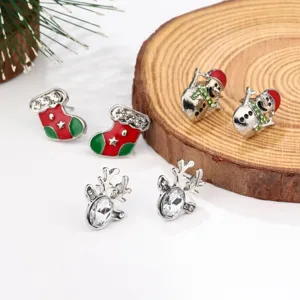 Detail view of festive Christmas stud earrings with snowman, deer, and stocking motifs