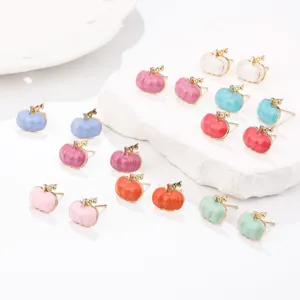Detailed view of colorful 3D pumpkin enamel stud earrings for Halloween and Thanksgiving