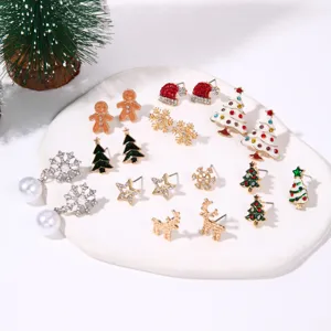 Detailed view of varied Christmas-themed stud earrings featuring trees, reindeer, and snowflakes.