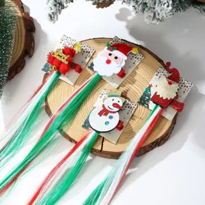 Detail view of four Christmas hair clips with long colorful synthetic hair on wood background